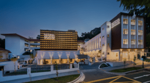 National Archives of Singapore building with modern design, illuminated signage, and landscaped surroundings.