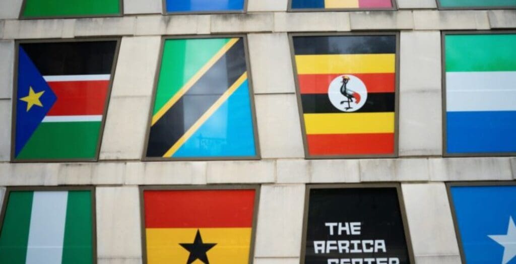 Wall with framed African national flags including South Sudan, Tanzania, Uganda, Nigeria, Ghana; "The Africa Center".
