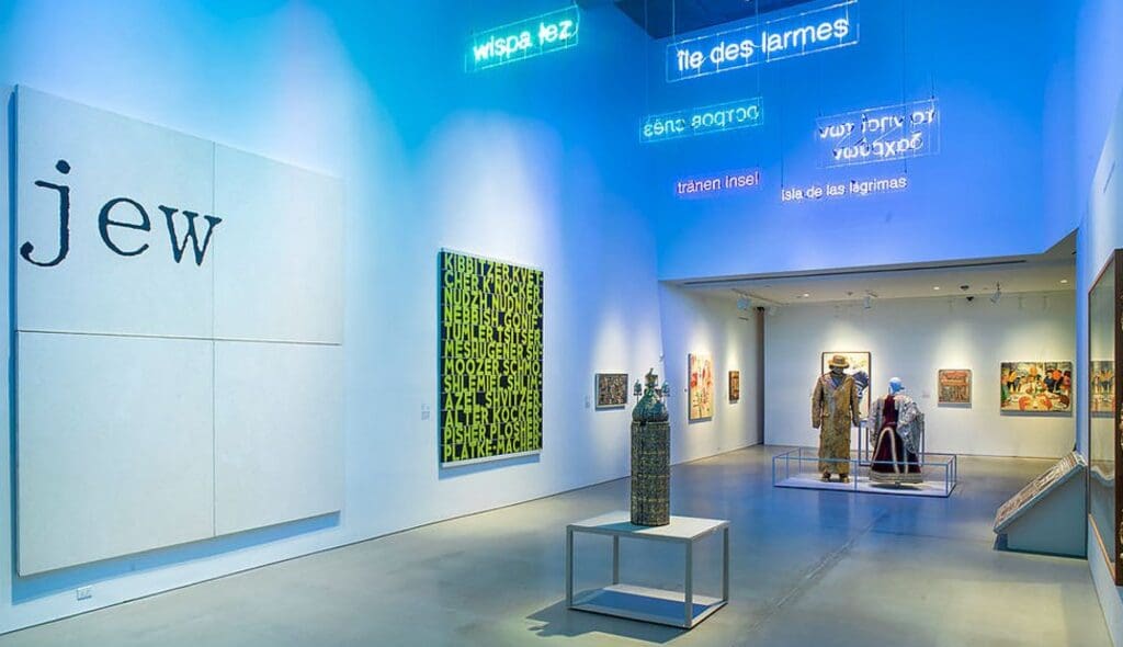 Brightly lit art gallery with diverse artworks, neon signs, and mannequins in the background.