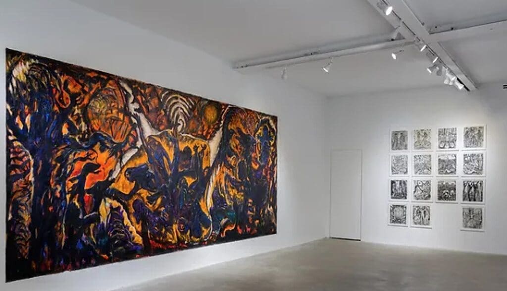 Bright gallery with large colorful abstract painting left, framed monochromatic artworks right, track lighting.