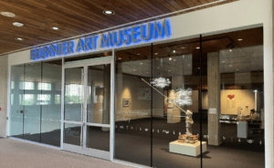 Entrance to Brunnier Art Museum with glass facade, wood ceiling, and Lori A. Jacobson Gallery inside.