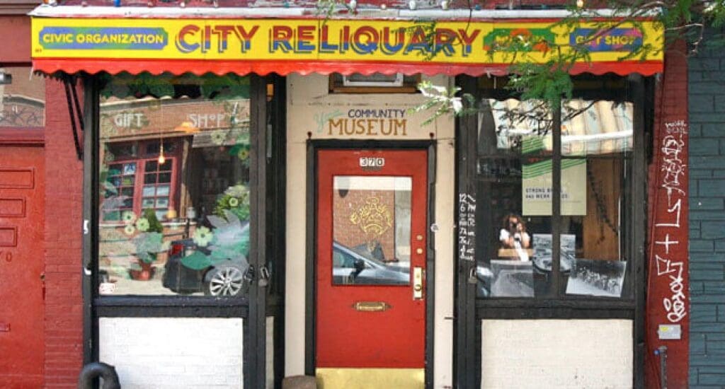 City Reliquary museum, civic organization, gift shop with red door and yellow-red awning