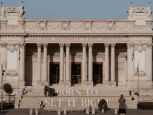 Galleria Nazionale d'Arte Moderna exterior with columns, statues, and text on steps reads, BORN TO SET IT RIGHT.