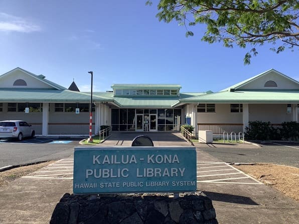 Kailua-Kona Public Library exterior with modern design, light facade, green roof, and surrounding area