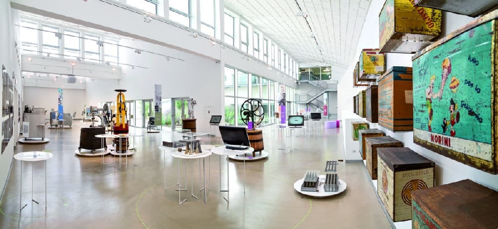 Modern art gallery with contemporary sculptures, installations, mixed media artworks, and natural light.