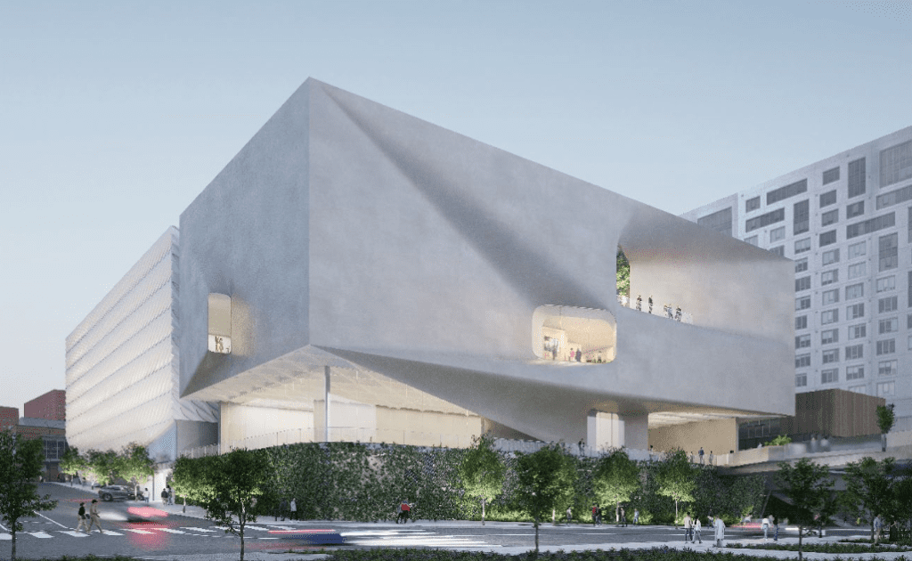 Large modern building with geometric shapes, rounded windows, balconies, greenery, and pedestrians.