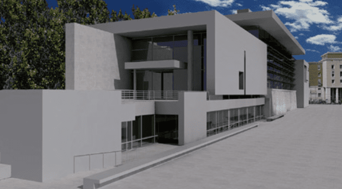Modern multi-level building with minimalist design, gray exterior, large windows, trees, and blue sky.