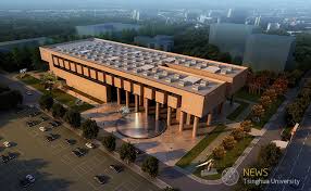 Aerial view of a modern university building at Tsinghua University with landscaped areas and parking.