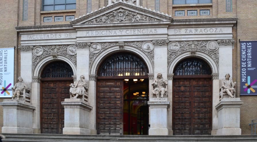 Entrance of the Museum of Natural Sciences in Zaragoza with ornate doors and stone carvings.