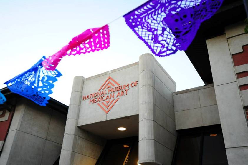 Entrance of National Museum of Mexican Art with colorful decorative paper banners above.
