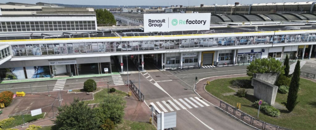 Modern industrial facility labeled "Renault Group ReFactory," with glass paneling and landscaped areas