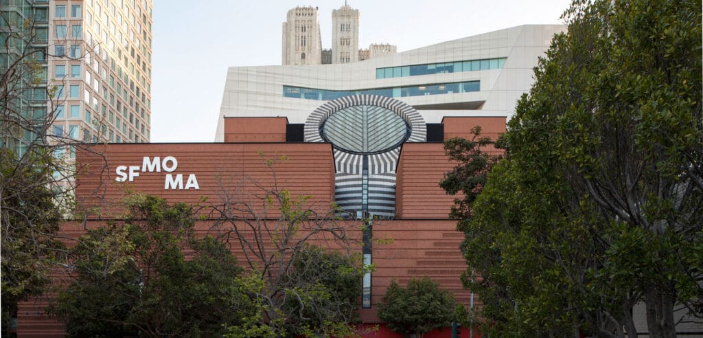 San Francisco Museum of Modern Art exterior with geometric design and urban high-rise backdrop.