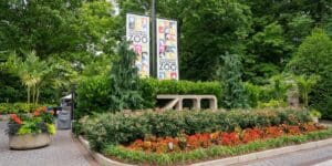 Entrance of Smithsonian's National Zoo with colorful flowers, greenery, banners, and a ZOO sign