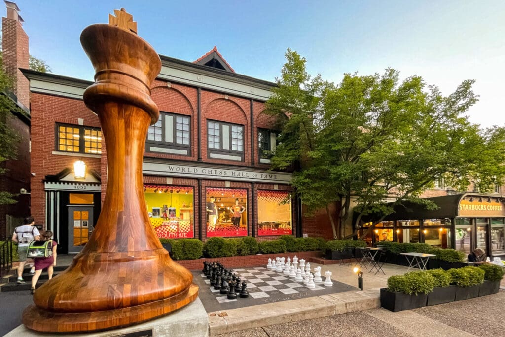 World Chess Hall of Fame with large wooden chess piece, outdoor chessboard, and adjacent Starbucks.