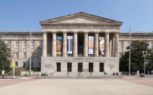 Smithsonian American Art Museum and National Portrait Gallery in neoclassical building with tall columns.